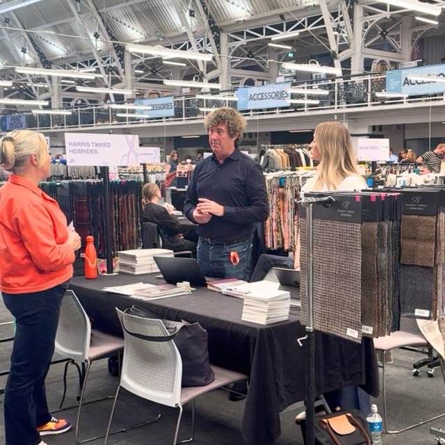Kate Hills talking to the Harris Tweed team on their stand at The London Textile Fair